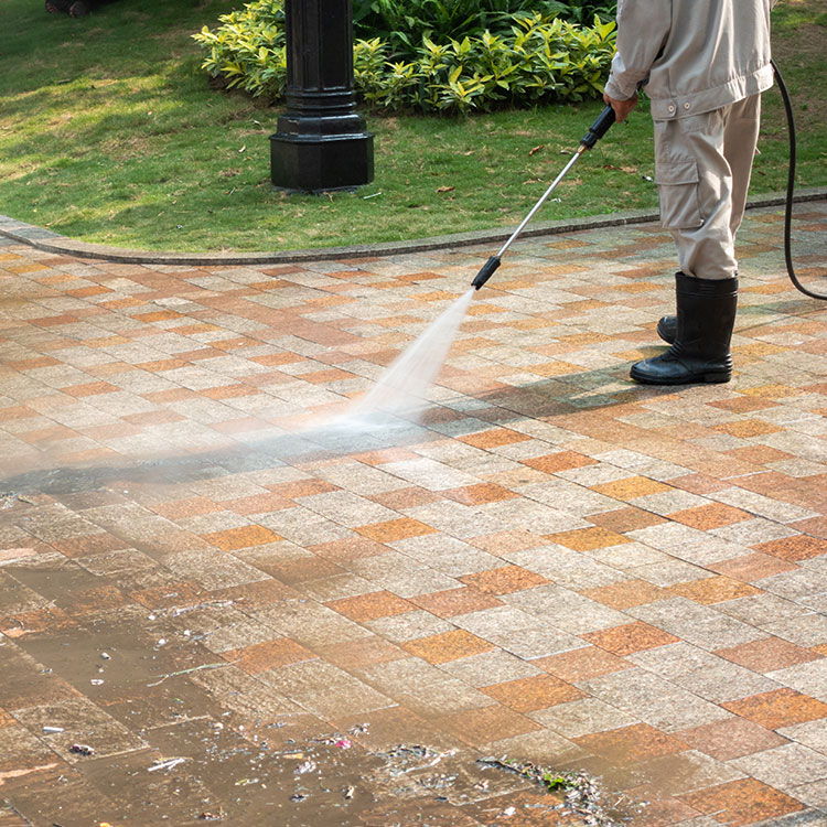 Picture of a driveway being pressure washed.