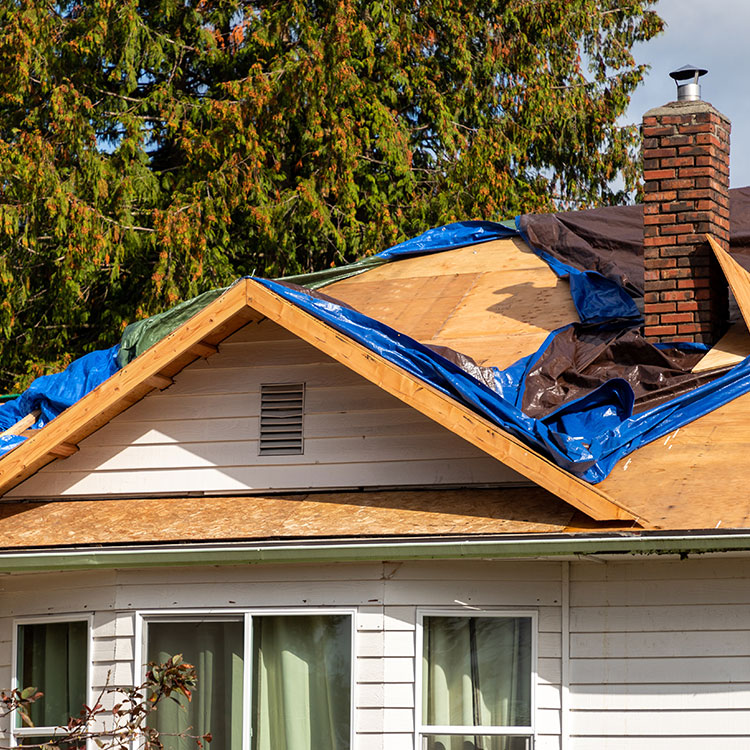 Picture of a roof with a tarp on top